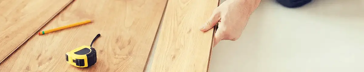 A professional installing wood flooring in Baltimore, MD