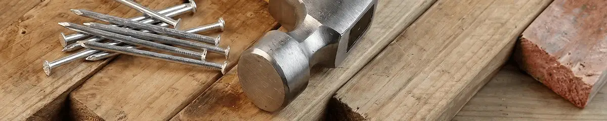 Hammer and nails on hardwood flooring boards in Baltimore, MD