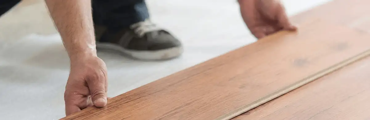 A professional installing laminate flooring in Baltimore, MD