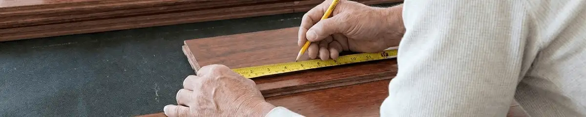 A professional installing wood flooring in Baltimore, MD